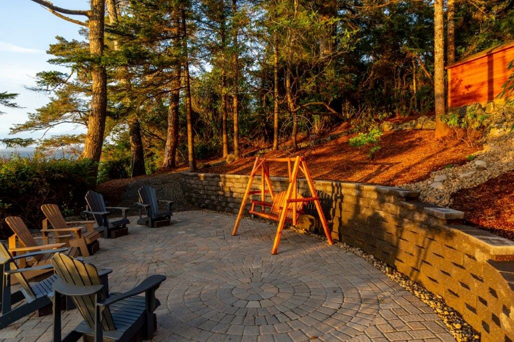 Stone patio and retaining wall installation overlooking lake