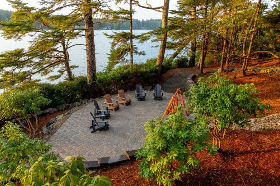Large stone patio and landscaping to accent lake view