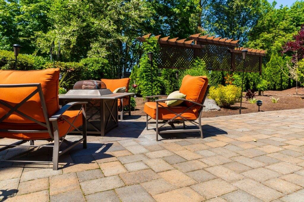 Stone patio installation bordered by trees